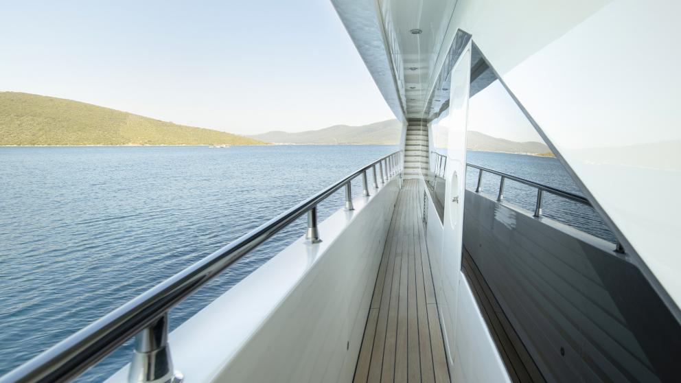 The exterior corridor of the luxury yacht, secured with stainless steel railings, is made of high-quality wooden floorin